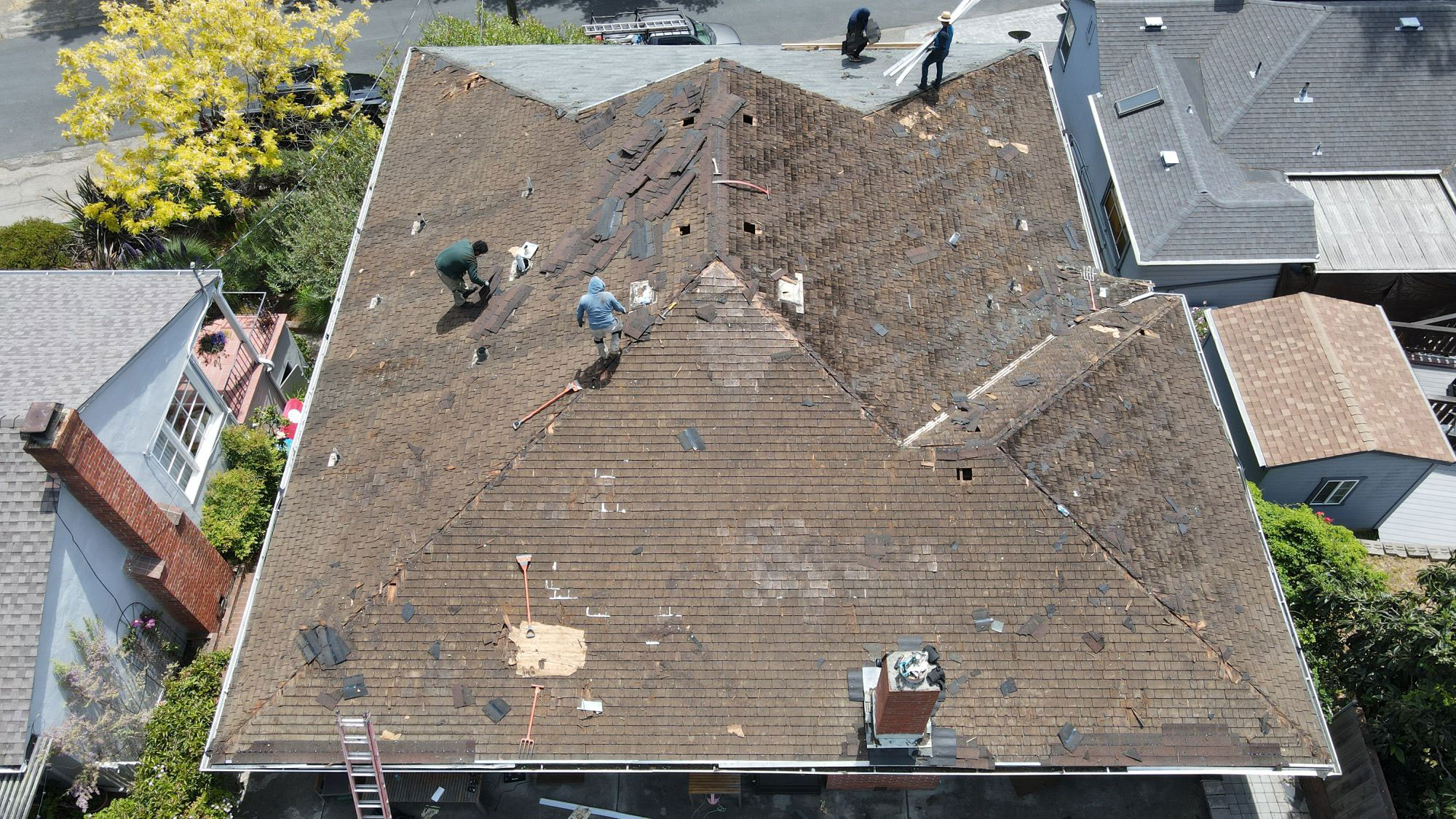 The image shows a roof under construction with visible materials and tools, indicating ongoing work on a residential building.